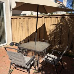 Barely used Patio Table With Umbrella And Four Chairs