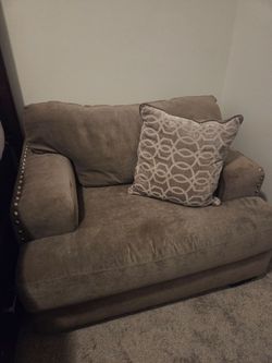 Gray oversized armchair with pillow