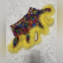 Vibrant mini skirt with smiley face pattern. Features bright yellow fur trim. Perfect for festivals and parties.  New xs neon happy face mini skirt fe