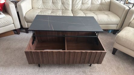 Coffee table with pop up table top and storage