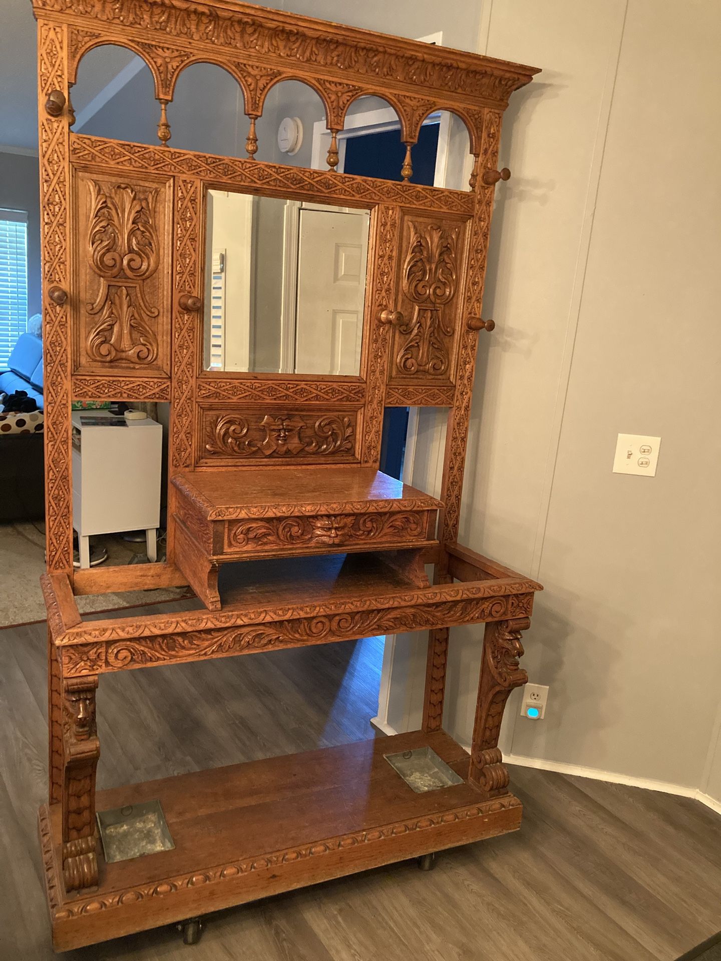 Antique hand carved hall tree with beveled mirror