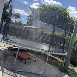 large trampoline with net & basketball hoop