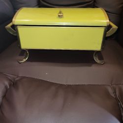 vintage Anchor Hocking Fire King chafing dish in yellow with a gold-tone stand and hinged lid.