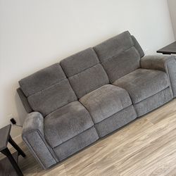 Dual recliner sofa  with a drop down console and hidden drawer 4  months old