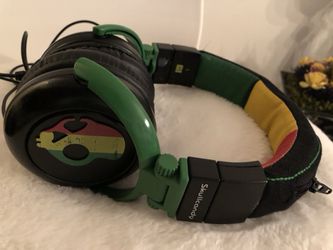black, green, and yellow Skullcandy corded headphones