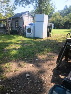 A dryer a refrigerator and a grill