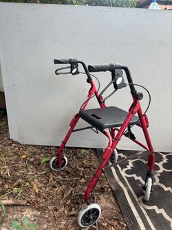 Red walker with seat and breaks