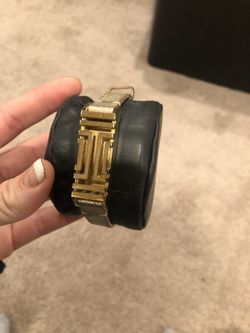 Tory Burch gold metallic Fitbit band with Fitbit and light baby blue workout band