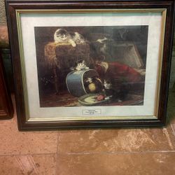 This item is a framed print titled "Kittens And The New Hat" by the artist Henriette Ronner-Knip.     