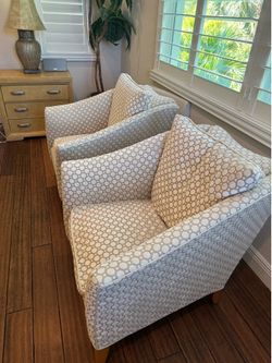 Accent armchairs featuring a distinct geometric circle pattern upholstery