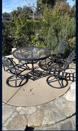 Patio furniture. glass top table with four chairs