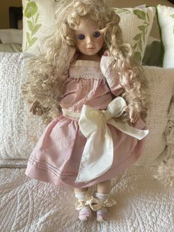 Porcelain doll with cloth body