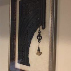 John Richards Chinese temple archway is presented in a gold-painted wooden shadowbox frame. The archway depicts a detailed scene of figures and includ