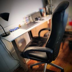 Leather desk chair, just a little wear on the palm rests.