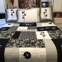 New black and white quilted bedspread with three pillows