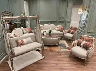 Luxury Living Set LOOK UP A modern luxury living room set with ornate carvings and plush upholstery. TIME PERIOD 21st Century ORIGIN Unknown, likely m