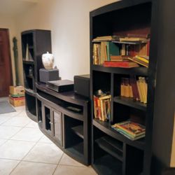  Black entertainment center with center pc. and 2 bookshelves/ends with multiple shelves and storage space.  Solid wood.