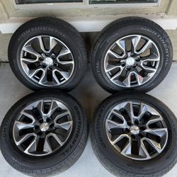 Set of 20-inch wheels with original 2023 Silverado tires in excellent condition.