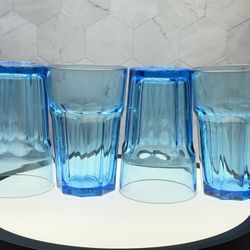 Set of (4) IKEA Pokal drinking glasses in the light Aqua/blue color. They are made of tempered glass for durability and are a classic, sturdy design p