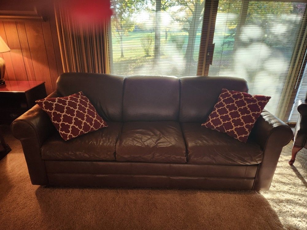 Leather sleeper sofa and two arm chairs with build in foot rest