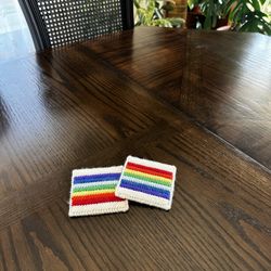 set of needlepoint rainbow coasters