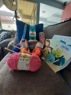 Bundle Of Knitting Supplies With Needles And Instructions
