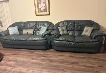 Two matching dark leather sofas