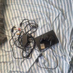 PS2 With Controller and Capcom game