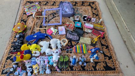 Variety of items – dolls, bags, toys, and decorations.  