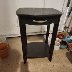 Dark brown side table with drawer