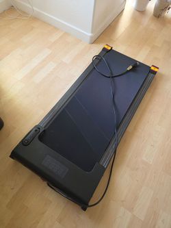 black under-desk walking pad treadmill.
