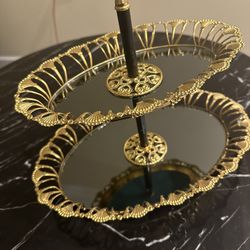 Gold colored, two-tier serving tray with mirrored surfaces,