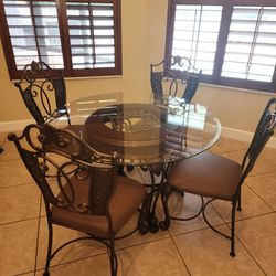 Kitchen Table, Chairs, and Matching Bar Stools. Table is 4 foot in diameter.  Seats four poeple.
