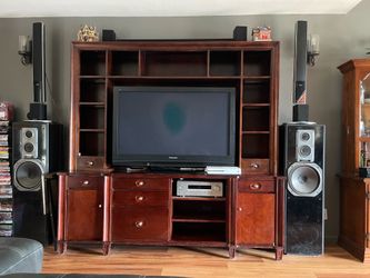 Entertainment center with Working TV and speakers sound bar and receiver.