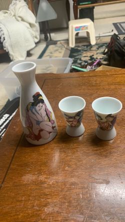 vintage Japanese porcelain sake set featuring a hand-painted geisha design.