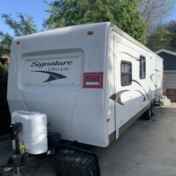 2012 Forest River 32’ long, sleeps 6 on 3 beds, has 2 side slide outs 