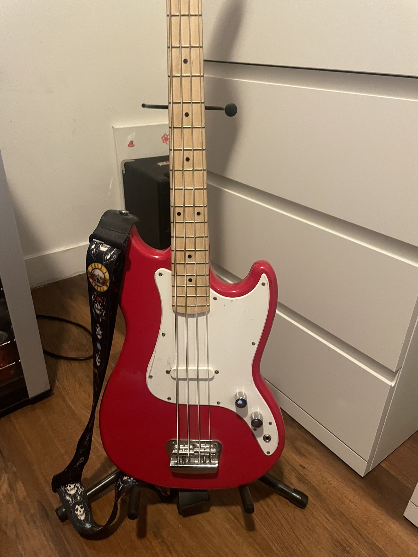 Red squier bronco bass guitar