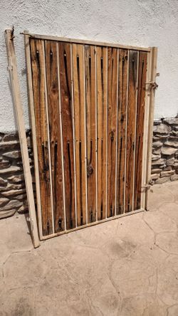 Metal door gate.  Natural wood panel.  Size. .4'feet wide. X. 5'feet tall.    $.   185