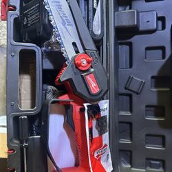 New 6 Inch Mini Lithium Chainsaw. It Comes With Two Batteries, Safety Glasses, And Safety Gloves.