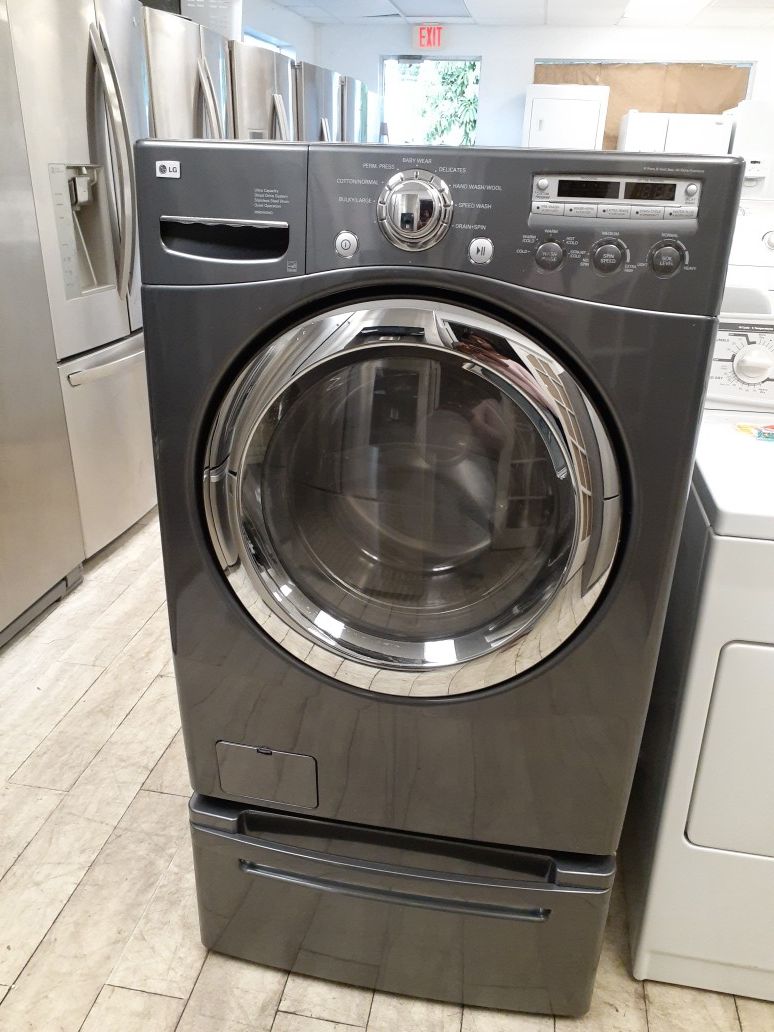 LG Smoke Grey Front Load Washer on pedestal