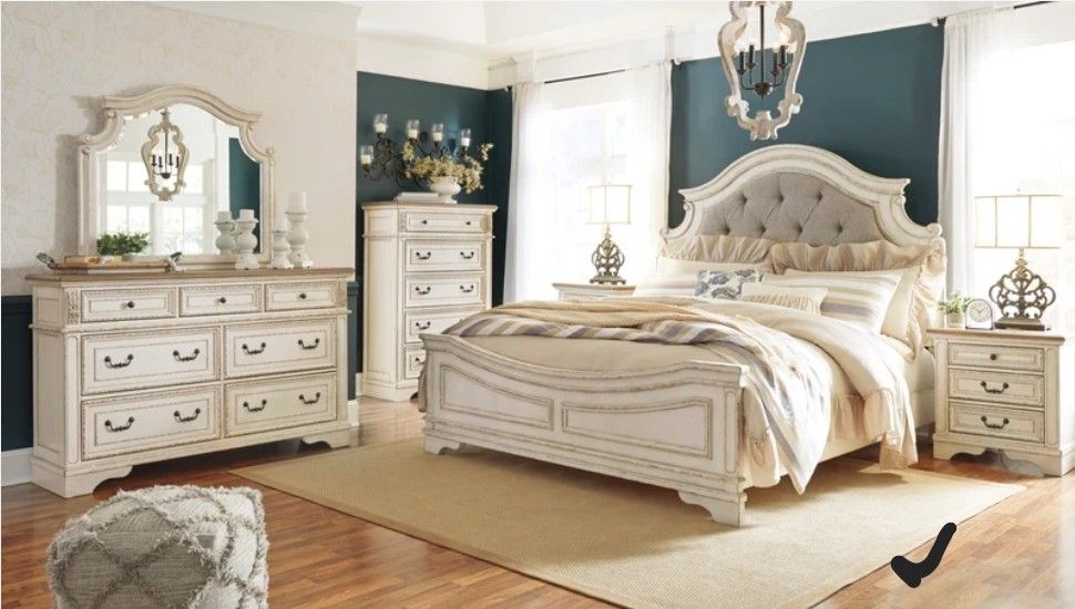 Realyn Chipped White Upholstered Panel Bedroom Set Bed Frame Dresser Mirror Nightstand Chest Included