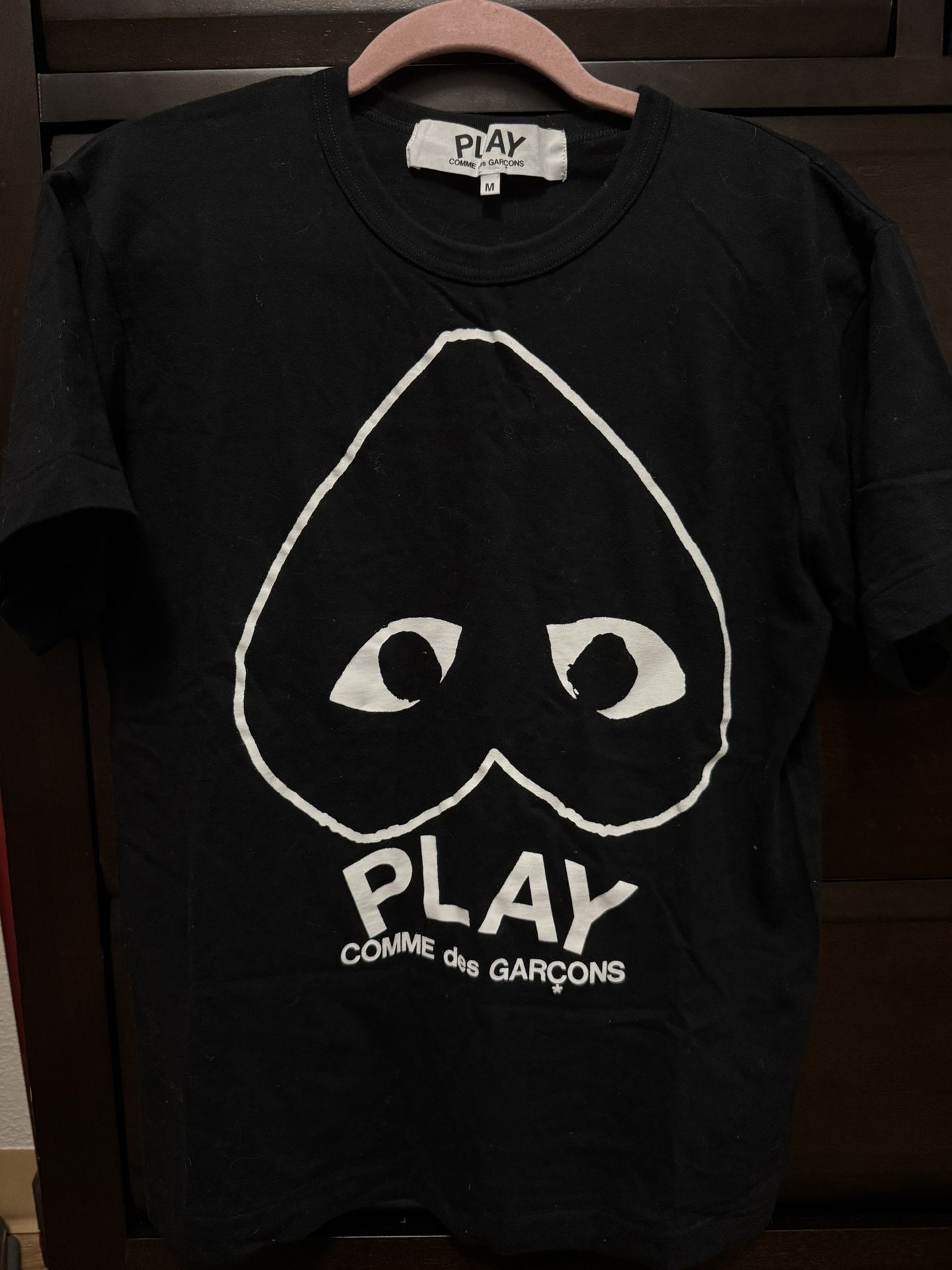 Comme de garçon black t shirt, fits between small to medium, women’s or small men’s