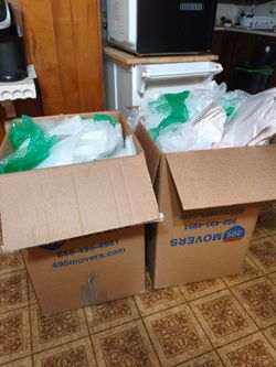 2 moving boxes filled with packing materials