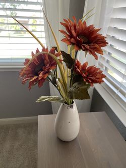 Faux flowers in vase.