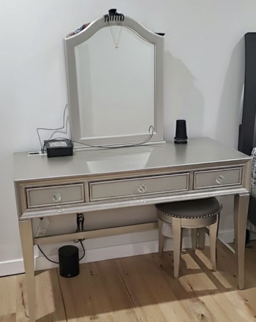 Vanity With Sliding Door Mirror And Hidden Jewelry Behind And Round Stool