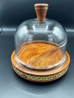 Teak wood cheese board paired with a clear glass dome cloche lid.