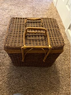 Brown wicker picnic basket with red picnic set