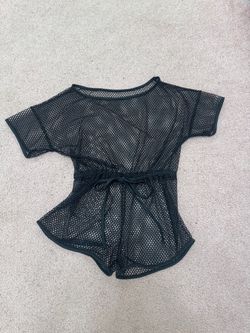 Lightweight black mesh one-piece designed for easy layering. Drawstring waist creates a flattering fit and keeps the cover-up secure. Breathable open-
