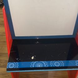 disney toddler desk with whiteboard and book cubbies in back.