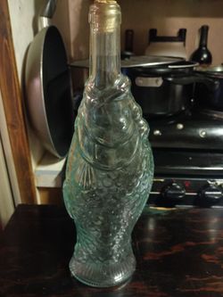 Vintage Italian pescevino glass bottle featuring a fish shape for sale.